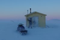 State Trooper visiting small cabin on snow machine
